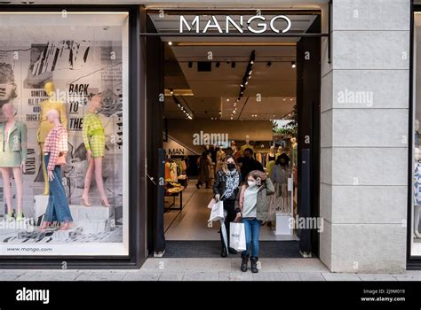 Shoppers leave the Spanish multinational clothing brand Mango store in ...