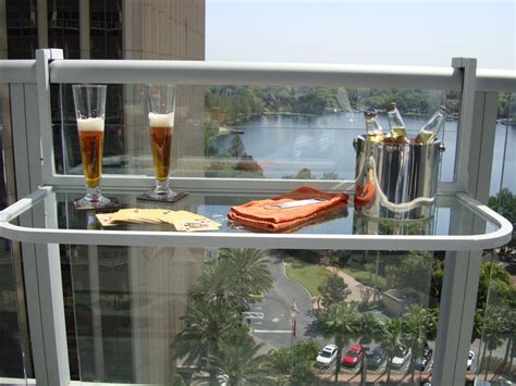 A Balcony With Drinks And Snacks On It