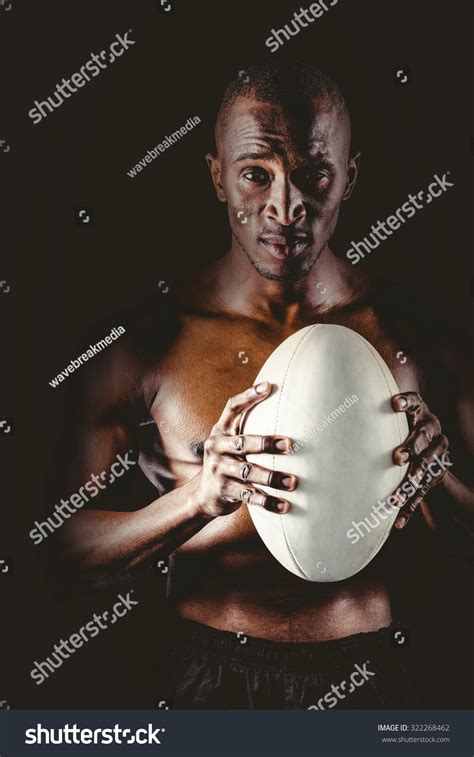 Portrait Confident Shirtless Sportsman Holding Rugby Stock Photo