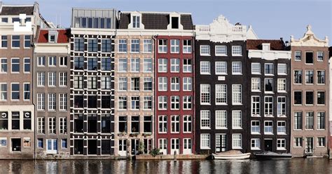 Brown And White Concrete Building Beside Body Of Water During Daytime Photo Free Amsterdam