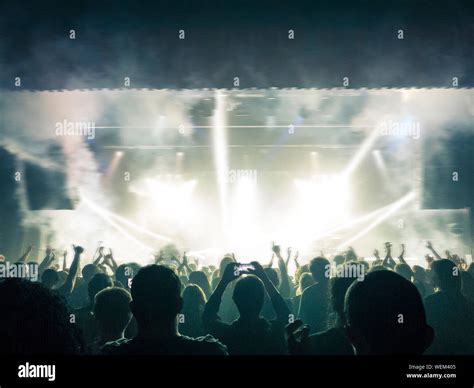 Colourful concert hall with clapping people Stock Photo - Alamy