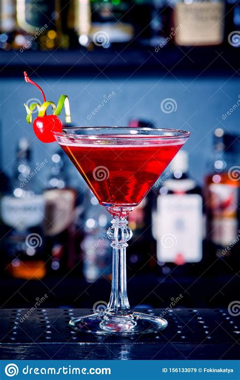 Red Drink Cocktail With Cherry In Martini Glass Cherry And Lime Peel