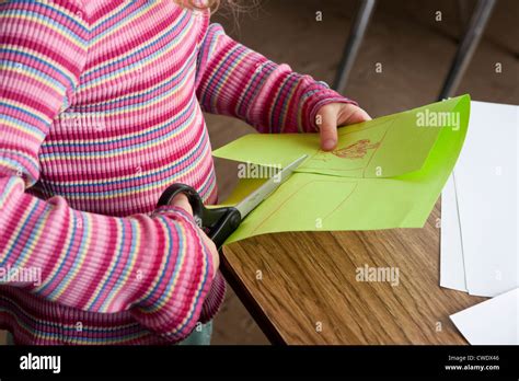 Young White 5 Year Old Girl In Colorful Sweater Uses Large Dangerous