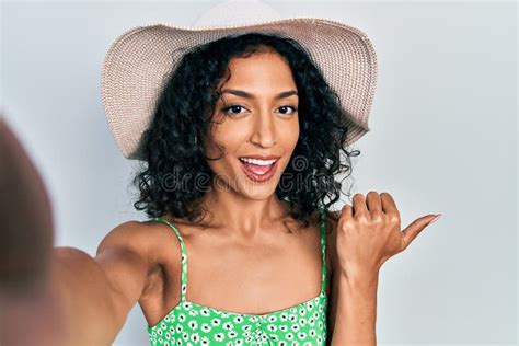 Young Latin Girl Taking A Selfie Photo Wearing Summer Style Pointing Thumb Up To The Side