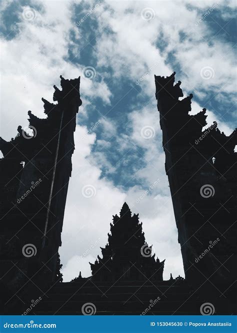 Silhouette Of Bali Temple At Sunny Day With Cloudy Sky At Background