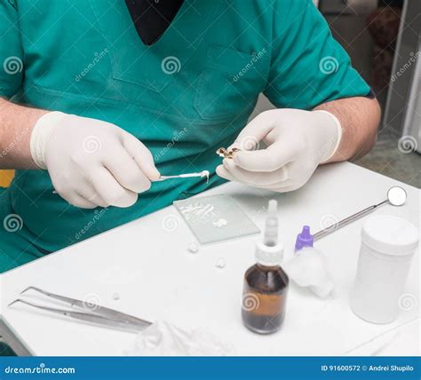 A Dentist Prepares An Implant In The Clinic Stock Photo Image Of