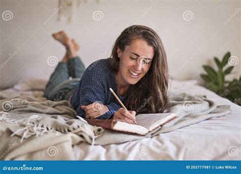 Woman Lying On Her Bed Writing In Her Journal Stock Image Image Of