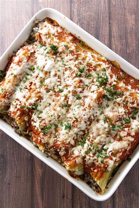 Baking Dish With Cheesy Beef Manicotti Topped With Sauce And Melted