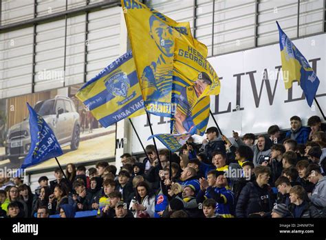 Warrington Wolves fans waving fans as the teams warm up Stock Photo - Alamy