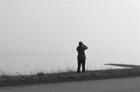 Premium Photo Rear View Of Woman Standing On Lakeshore Against Clear Sky