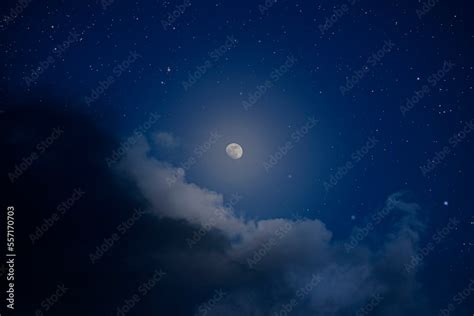 Moonlit night sky with clouds and stars Stock Photo | Adobe Stock