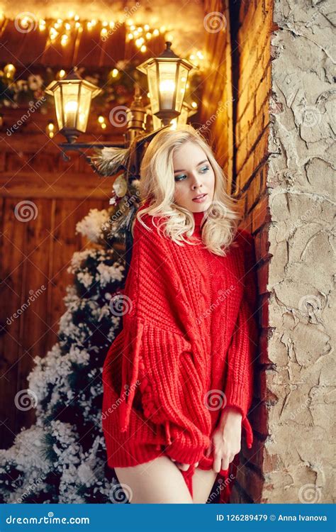 Christmas Fashion Woman Blonde In The Red Sweater Having Fun And Posing Against The Christmas