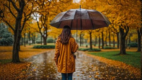 Premium AI Image | Lonely girl stands in the autumn park rain