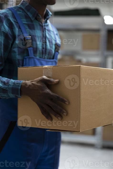 Manual labor tasks in industrial warehouse involve checking shipments