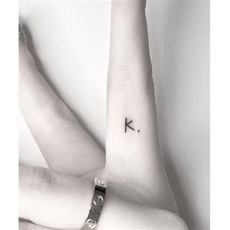 Tiny Minimalistic Letter K Tattoo Located On The