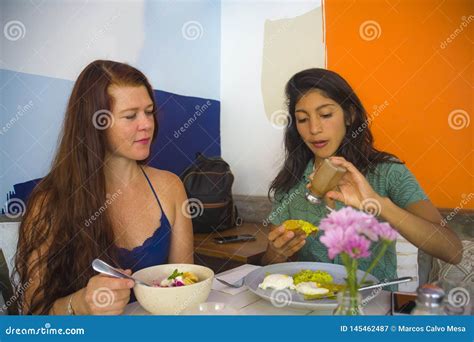 Lifestyle Portrait Of Young Attractive Hispanic Girl Sitting At Modern