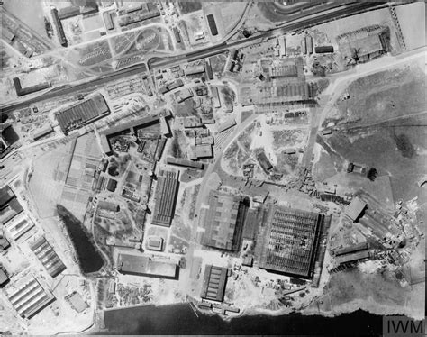 an old black and white photo of a large factory complex in the middle of nowhere