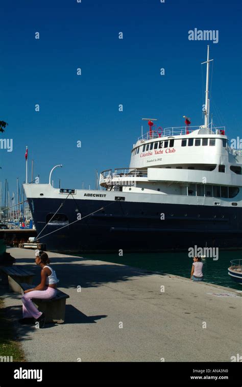 Two Tourists Sitting By The Headquarters Of Columbia Yacht Club A