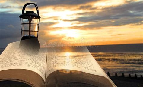 Open Bible Lantern Lamp On Beach At Sunset