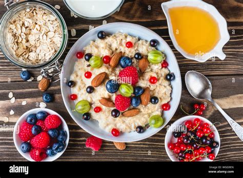 Healthy Breakfast Bowl Of Oatmeal Porridge With Berries Nuts Honey