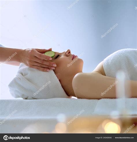 Young Woman Lying On A Massage Table Relaxing With Eyes Closed Woman