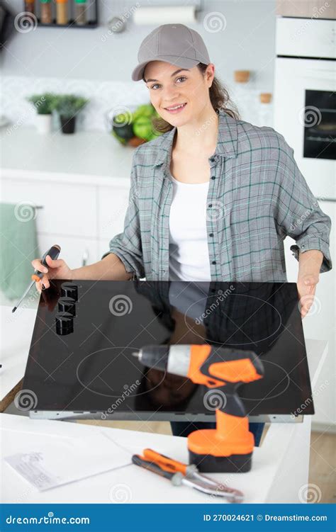 Woman Installing Hob in Kitchen Stock Image - Image of slide ...