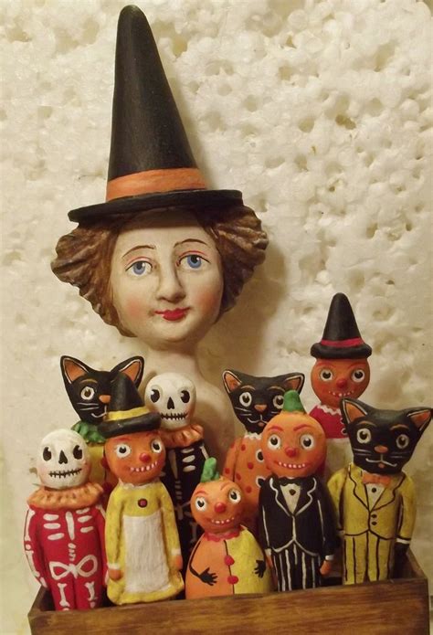 A Group Of Halloween Figurines Sitting On Top Of A Wooden Box