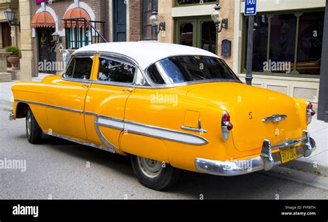 yellow 50's inspired vintage car Stock Photo - Alamy