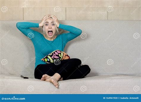 Beautiful Young Surprised Woman Watching TV at Home Alone Stock Photo ...