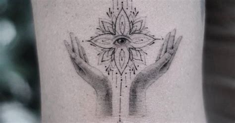 Evil eye and hands tattoo located on Hilary Duff's