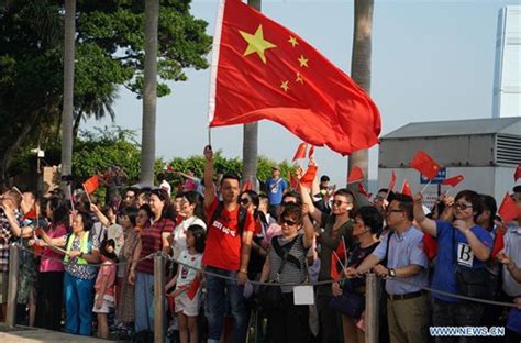 People Attend National Flag Raising Ceremony At Golden Bauhinia Square