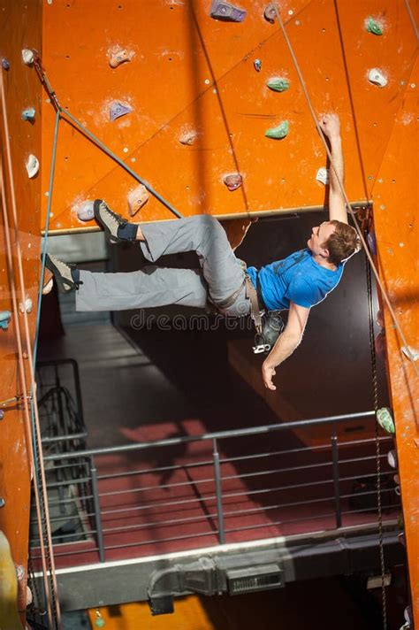 Male Rock Climber Practicing Climbing On Rock Wall Indoors Stock Image