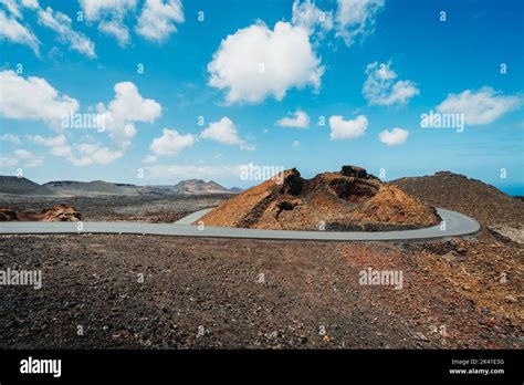 Asphalt Road In Volcanic Arid Landscape Of Timanfaya National Park