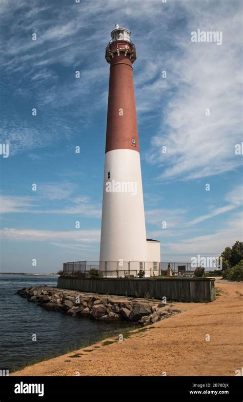 Barnegat Lighthouse On Long Beach Island New Jersey Against A Blue Sky