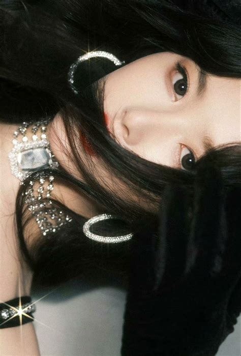 A Woman With Long Black Hair Wearing Jewelry