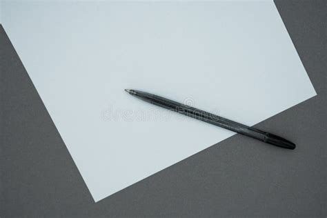 Blank White Paper and Black a Pen on Gray Background. Top View Stock ...