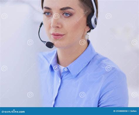 Serious Pretty Young Woman Working As Support Phone Operator With