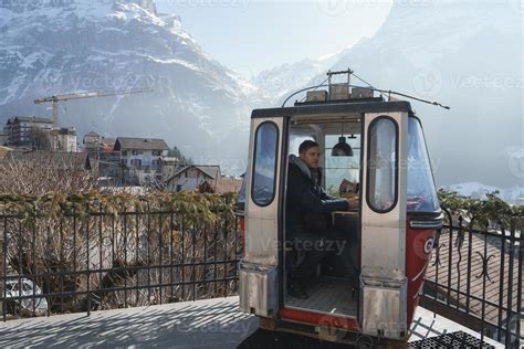 Tourist sitting in overhead cable car at luxury hotel during vacation ...