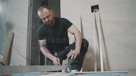 Man Works in Slow Motion on Tile Installation Inside a Modern ...