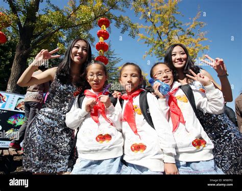 A Pair Of Chinese Twins Pose With Three Young Triplet Girls At The 8th