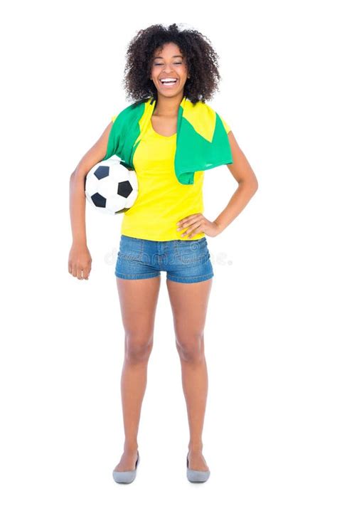 Pretty Football Fan Holding Brazilian Flag Smiling At Camera Stock