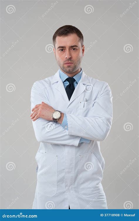 Portrait Of Mature Serious Male Doctor With Crossed Arms Stock Photo