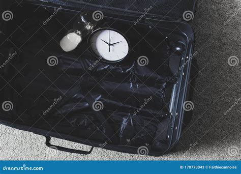 Time To Travel Or Delay During A Trip Empty Suitcase With Clock And