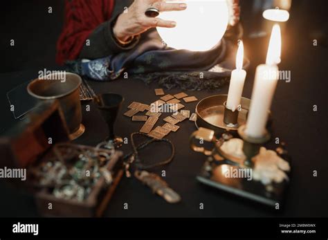 Soothsayer Using Crystal Ball To Predict Future At Table In Darkness