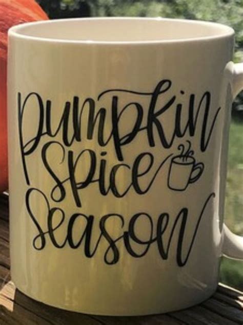 A Coffee Mug With The Words Pumpkin Spice Season Written On It