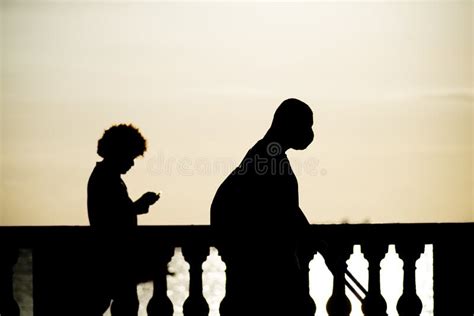 People Are Seen Walking And Having Fun At Sunset On The Porto Da Barra