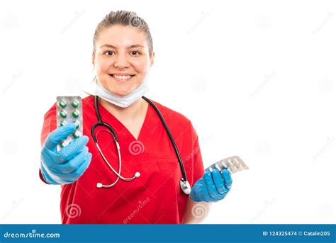 Young Medical Nurse Wearing Red Scrub Showing Tablets Blisters Stock