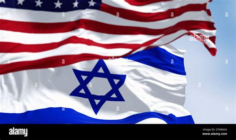 State of Israel national flag waving in the wind with the American flag ...