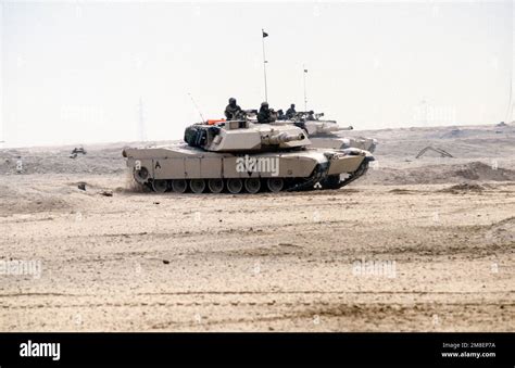 Two Marine Corps M-1A1 Abrams main battle tanks move across the desert ...