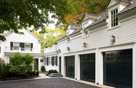 White Garage And House Black Shutters And A Black Garage Door